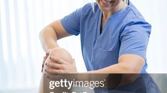 physician reviewing imaging with athlete + parent