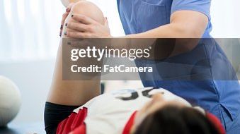 physio guiding a movement in clinic